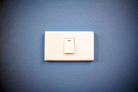 light switch on blue background, vignette cornerの写真素材