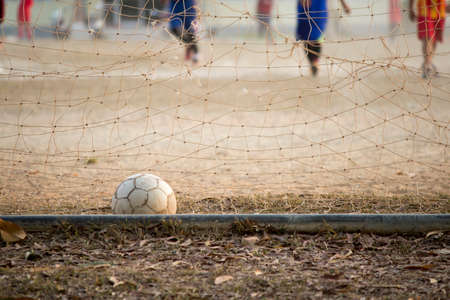 old football in the goal, children are playingの写真素材