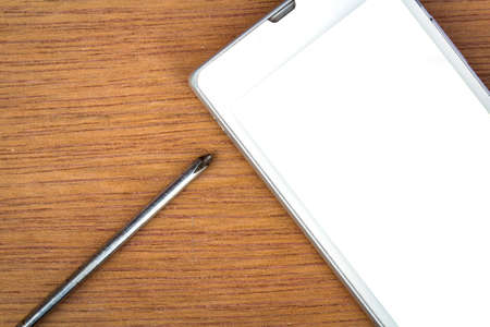 smart phone and screwdriver for repair,  top viewの写真素材