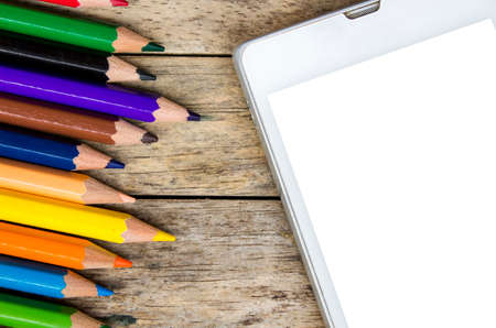 pencils color and smart phone on wood background, top view, white screenの写真素材
