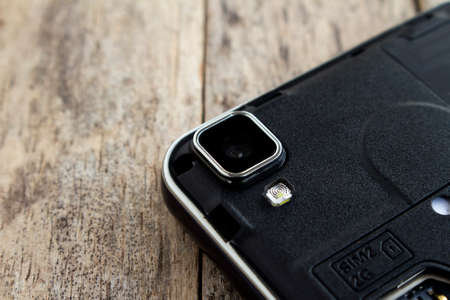 close up lens of smart phone on wood backgroundの写真素材