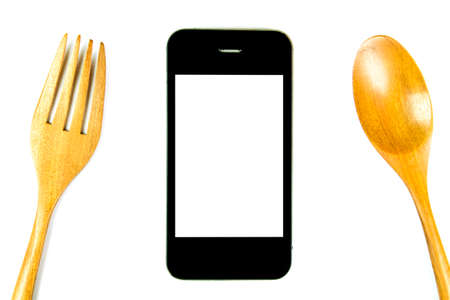 smart phone with fork and spoon on white background, use phone with eatingの写真素材