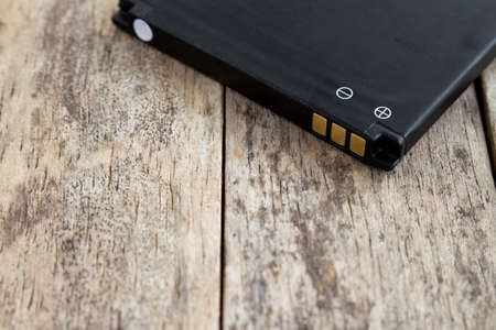 battery of smart phone on wood background, soft focused, copy spaceの写真素材