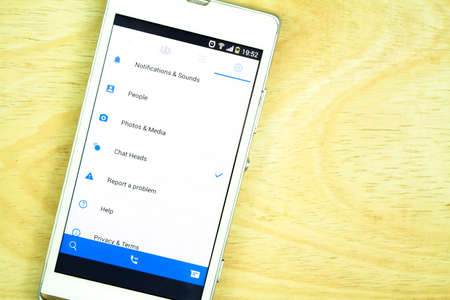 BUNG KAN, THAILAND - JANUARY 15, 2016: smart phone display facebook messenger app on office deskのeditorial素材