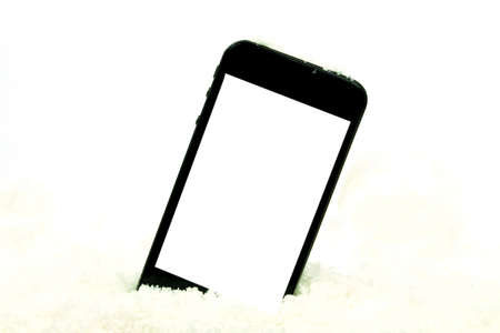 smart phone on snow on white backgroundの写真素材