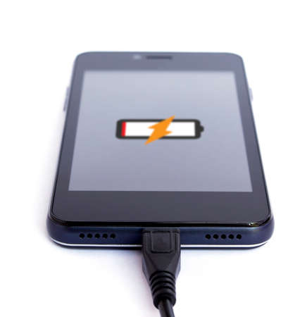 Smart phone is charging on white backgroundの写真素材