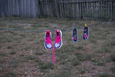 shoes on a rope are dried hangingの写真素材
