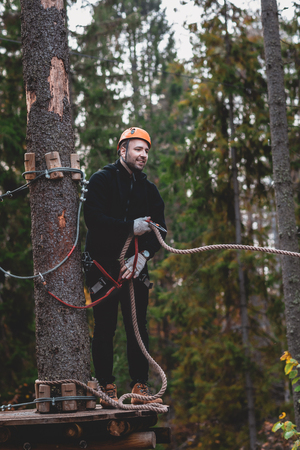 Man in a park on a Adventure Park. rope town. country park for sportsの写真素材