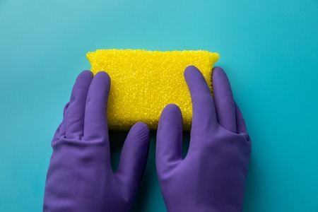 cleaning on blue background. two hands holding a sponge for washing. Flat lay, Top view.の写真素材