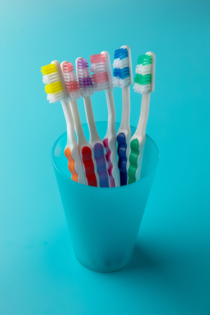 toothbrushes in a blue glass.の写真素材