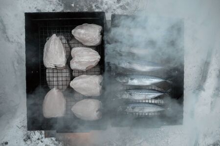 grilled chicken and fish in smokehouse.の写真素材