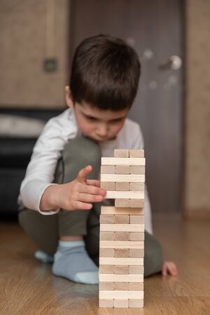 Wooden Tower Game. Child plays at home in constructionの写真素材