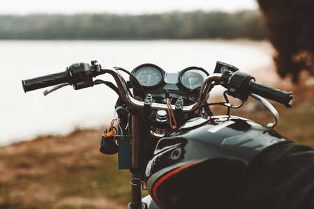 Front view motorcycle on a sandy beach on the background of the coastの写真素材