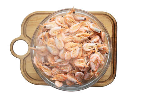 cooked shrimp. isolate glass plate with seafood on wooden boardの写真素材