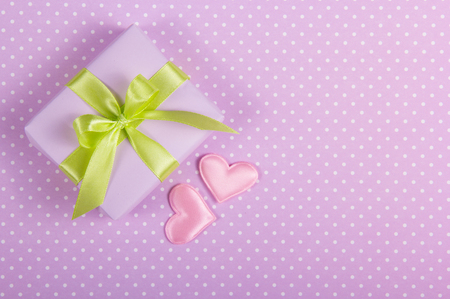 A small box with a bow and valentines on a polka dot background. Valentine's Day. Copy space.の写真素材