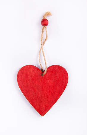 Red heart made of wood. Wooden pendant in the shape of heart.の写真素材
