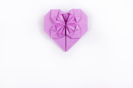 Heart of origami of purple paper on a white background. Copy space.の写真素材