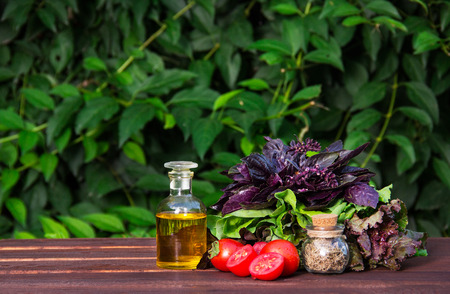 Olive oil, fragrant herbs and tomatoes. Fresh basil and tomatoes. Ingredients for summer salad.の写真素材