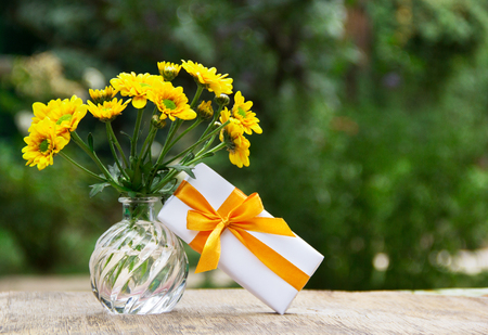 A bouquet of wildflowers and a small gift box. A romantic gift.の写真素材
