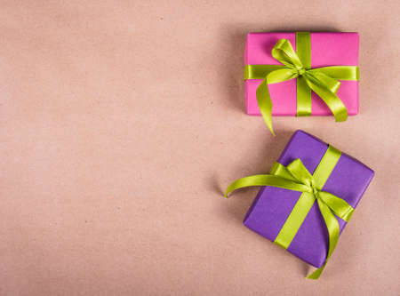 Bright gift boxes on a brown paper background. Copy spaceの写真素材