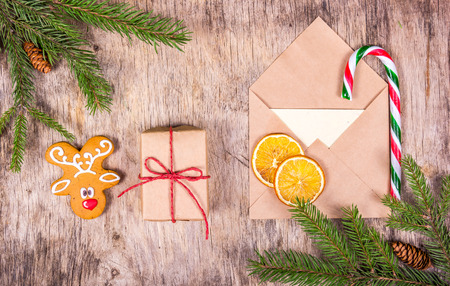 Christmas decoration with fir tree, gingerbread, gift and an envelope. Letter to Santa Claus.の写真素材