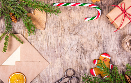 Christmas decoration with a tree, chic, gingerbread man, gift, envelope, candy cane and scissors. Preparing for Christmas. Gift wrapping. Copy spaceの写真素材