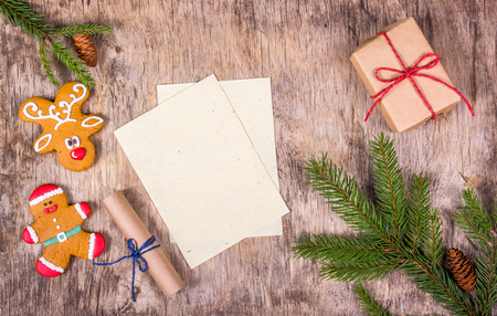 Christmas decorations with fir tree, gingerbread and gift box. Blank sheet on christmas background.の写真素材