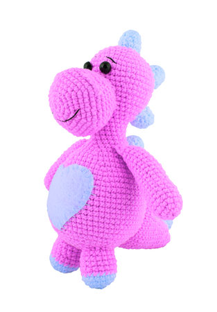 Pink knitted dragon. Knitted toys. Amigurumi. Isolated on white.の写真素材