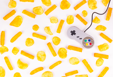 Gray joystick and potato chips. Harmful food and gamepad. GamePad.の写真素材