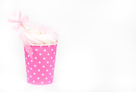 Paper cup with drink. Latte with marshmallows in paper cup. Copy space. Simple Backgroundsの写真素材
