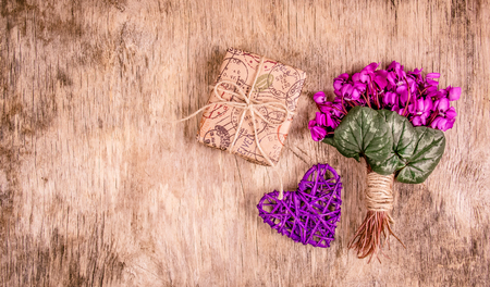 International Women's Day. Gift box and spring flowers. Delicate violets and heart.の写真素材
