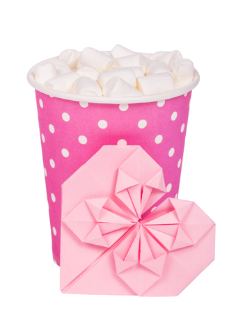 Pink paper glass with hot drink. Latte with marshmallow in pink glasses. Coffee and Valentine card. Isolated on whiteの写真素材
