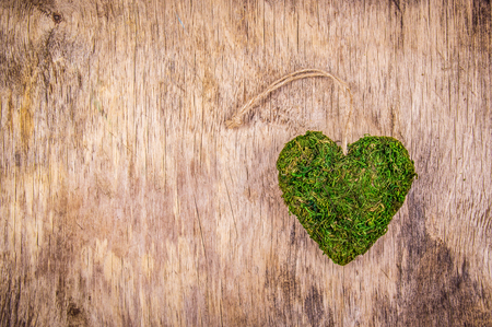 Heart of moss. Green heart on  wooden background. Eco style. Eco gift. St. Valentine's Day. Copy spaceの写真素材