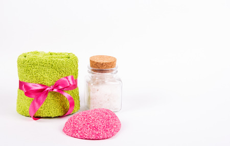 Terry towel, pink soap and sea salt on white background. Spa concept. Romantic concept. Copy spaceの写真素材
