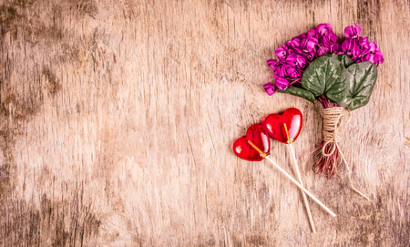 Bouquet of tender violets and lollipops. Heart shaped lollipop.  Spring color. Romantic concept.の写真素材