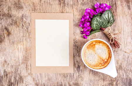 Cup of coffee, spring flowers and blank sheet of paper. Romantic letter and flowers. Copy spaceの写真素材