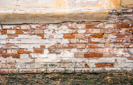 Old brick wall, foundation and plaster.
The wall of the old house.の写真素材