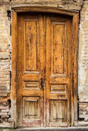 Old wooden door. Crooked door in the old house.の写真素材