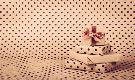 Stack of gifts. Gift boxes. Paper polka dot background. Copy spaceの写真素材