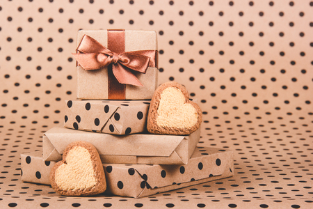 Stack of gifts and cookies hearts. Gift boxes. Festive decorations. Heart shaped cookiesの写真素材