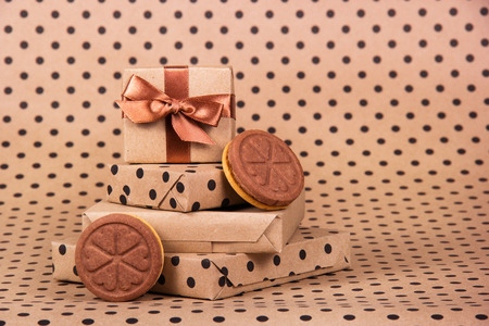 Gift boxes and chocolate cookies. Cookies with hearts. Stack of gifts.の写真素材