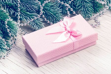 Beautiful christmas gift box close up. Pink gift box with bowの写真素材