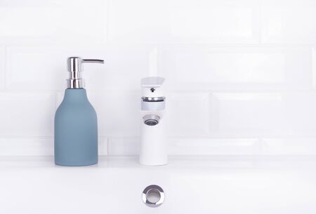 Liquid soap in the bathroom. White sink and soap. Bottle with liquid soap on a white backgroundの写真素材