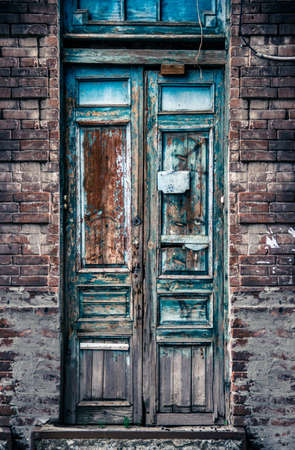 Old wooden door with peeling paintの写真素材
