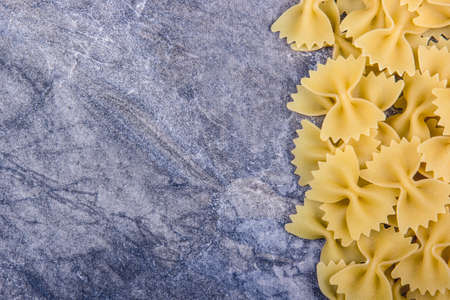 Italian pasta farfalle on gray background. Copy spaceの写真素材
