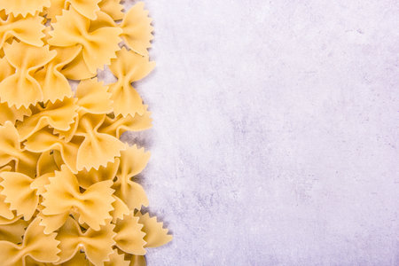 Italian pasta farfalle on gray background. Italian pasta farfalle Copy spaceの写真素材