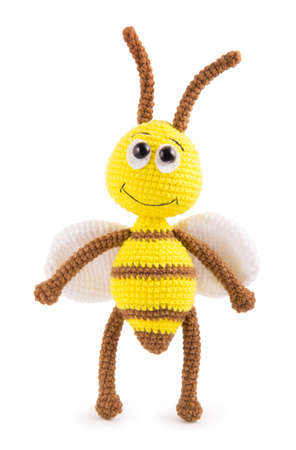 Soft knitted toy bee on a white backgroundの写真素材