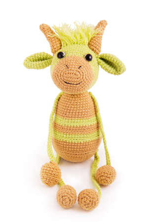 Soft knitted toy bull on a white backgroundの写真素材