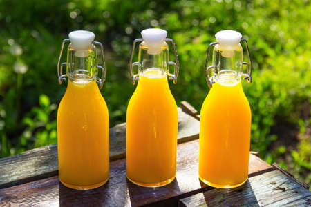 Orange juice in bottles. Summer cold orange drinkの写真素材