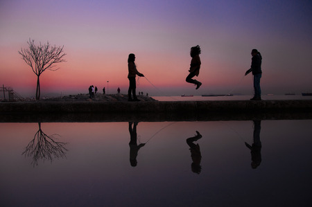 silhouette of children playingのeditorial素材